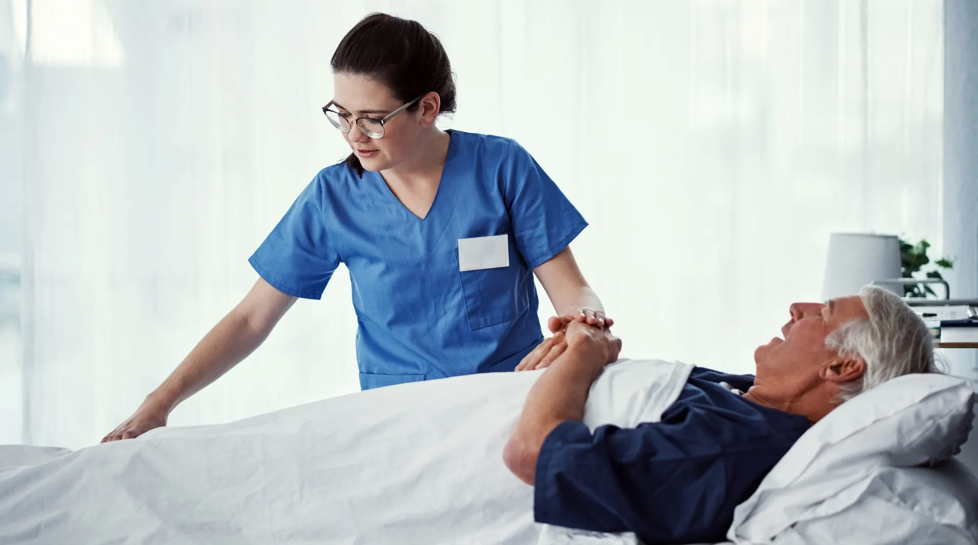 Nurse offering gentle bedside palliative support